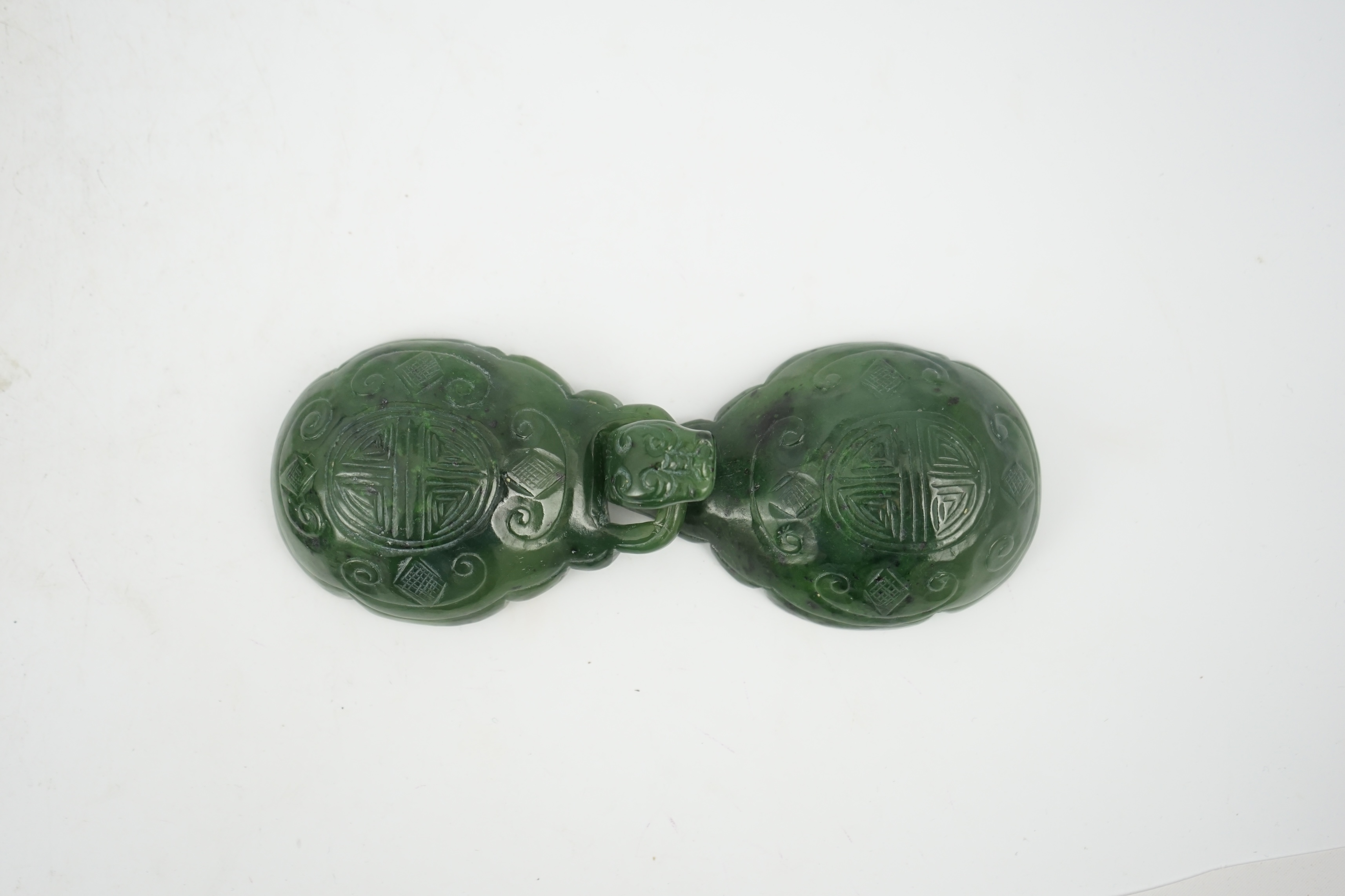 A Chinese spinach green jade two-piece belt buckle, 18th/19th century